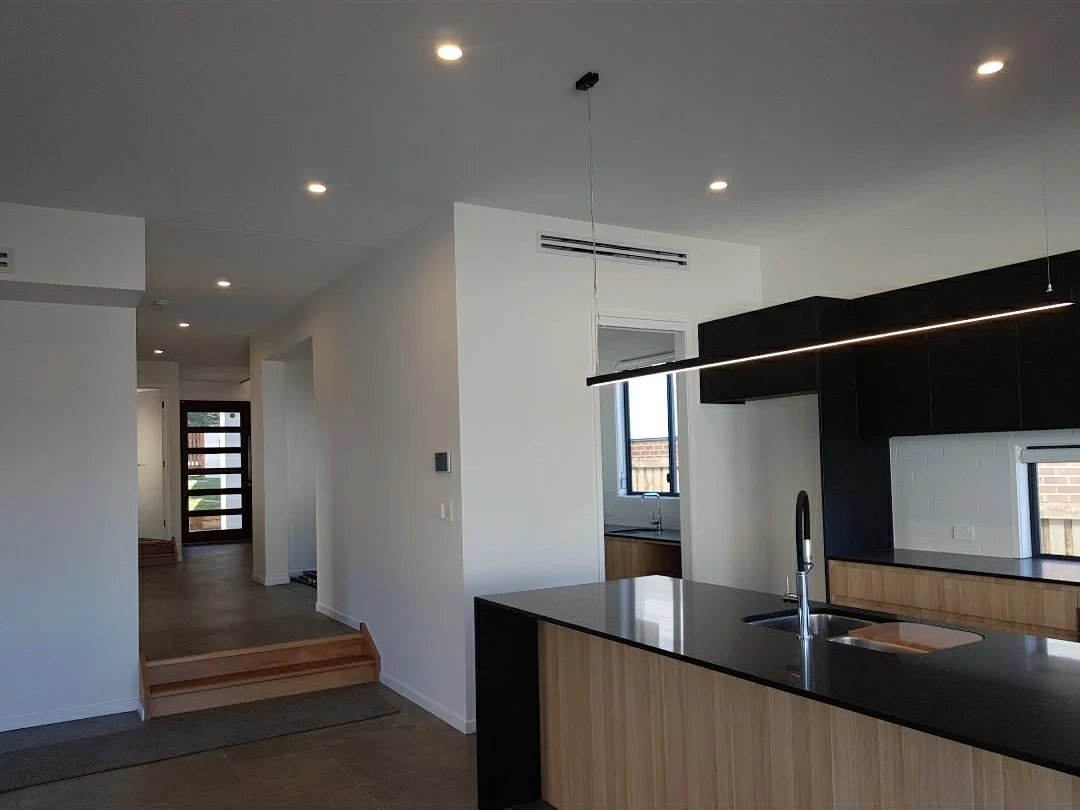 Completed kitchen with pendant lighting, downlights and electrical fittings